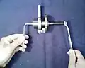 5. Using an a 5 mm hex key and holding the end of the micrometer spindle, adjust the clutch. A right-handed turn tightens the clutch.