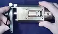 3. Remove the four screws fastening the bearing disk to the end of the barrel.