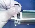 4. With the socket pinned to the screw and a 3 mm hex key as lever, the obstinate screw is loosened.