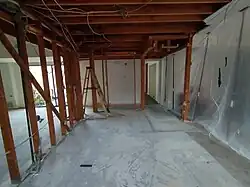 Removal of dry wall and building insulation from the ceiling and the suspended ceilings; removal of some wall studs; installation of a temporary support (right)