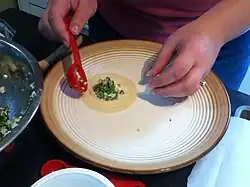 Step 3: Put 1 tablespoon of filling into the center of the wrapper.