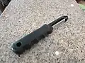 A simple potato peeler on a kitchen countertop.