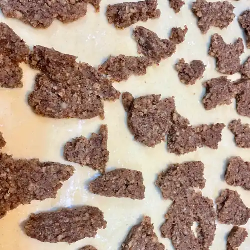 Pieces of nut filling scattered across the dough.