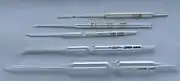 Carlsberg pipettes, glass micropipettes named for their place of invention and first use, The Carlsberg Laboratory, Physiology Department, Copenhagen, Denmark. Used with a mouthpiece for precision biochemical and physiological lab work., From the top: double constriction pipettes for 1 and 10 microlitres; single constriction pipettes for 200; 2,000; and 10,000 microlitres