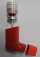 A round canister above an orange plastic holder