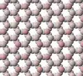 View of tetrahedral sheet structure of talc. The apical oxygen ions are tinted pink.