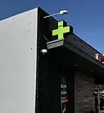 Pharmaceutical store light up sign secured on building front