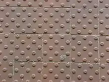 A grid of tiles, each with a grid of bumps on them