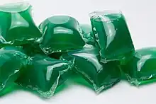 A pile of green laundry pods