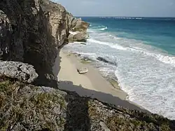 From above the beach reveals some unwelcoming rocks and the photographer could not spot an obvious way up or down.